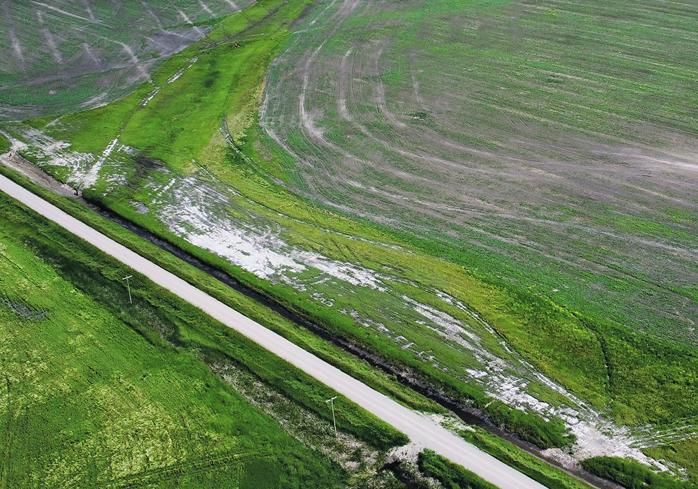 Tile drainage offers producers a tool to reduce or control soil salinity (foreground), which can be a significant limitation to crop production across the Prairies.  |  David Whetter photo