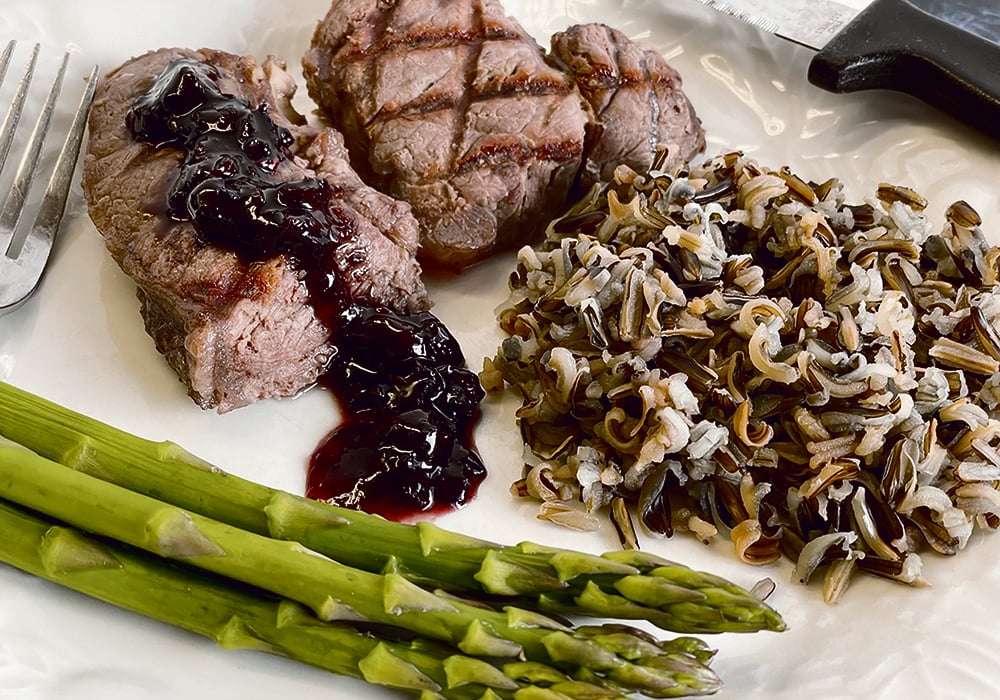 Bison steak with a saskatoon berry jam glaze, wild rice and asparagus were all foods that helped increase cash flow on many farms during the 1980s. | Betty Ann Deobald photo