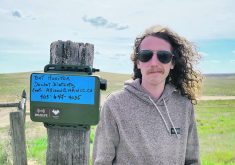 Tyler Eresman, a wildlife and outreach technician with the Milk River Watershed Council Canada, stands next to a bat monitor.  |  Photo supplied by Milk River Watershed Council Canada