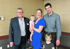 Canada’s Outstanding Young Farmers program president Danny Penner, left, poses with Marcus and Paige Dueck and their children, Sutton and Brielle.  |  Manitoba Outstanding Young Farmers photo