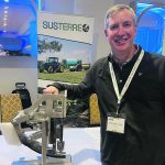 Susterre CEO Michael Cully is shown with the company’s high pressure water jet unit that fits onto planters and opens up residue and the soil for the rest of the seed placement system. | John Greig photo