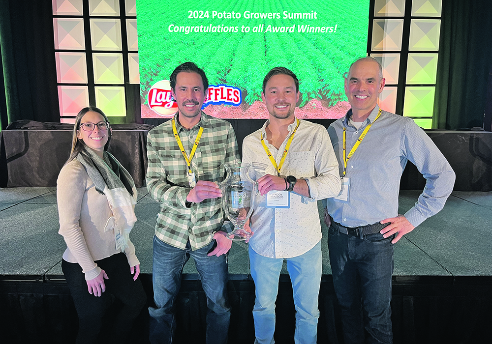 Nakamura Farms agronomist Paige Fletcher, left, Ryland Nakamura, Lyndon Nakamura and Georges Dion, Frito Lay’s potato buyer, celebrate the farm receiving an award that recognizes producers with top growing practices, potato quality and record keeping.  |  Photo supplied by Ryland Nakamura