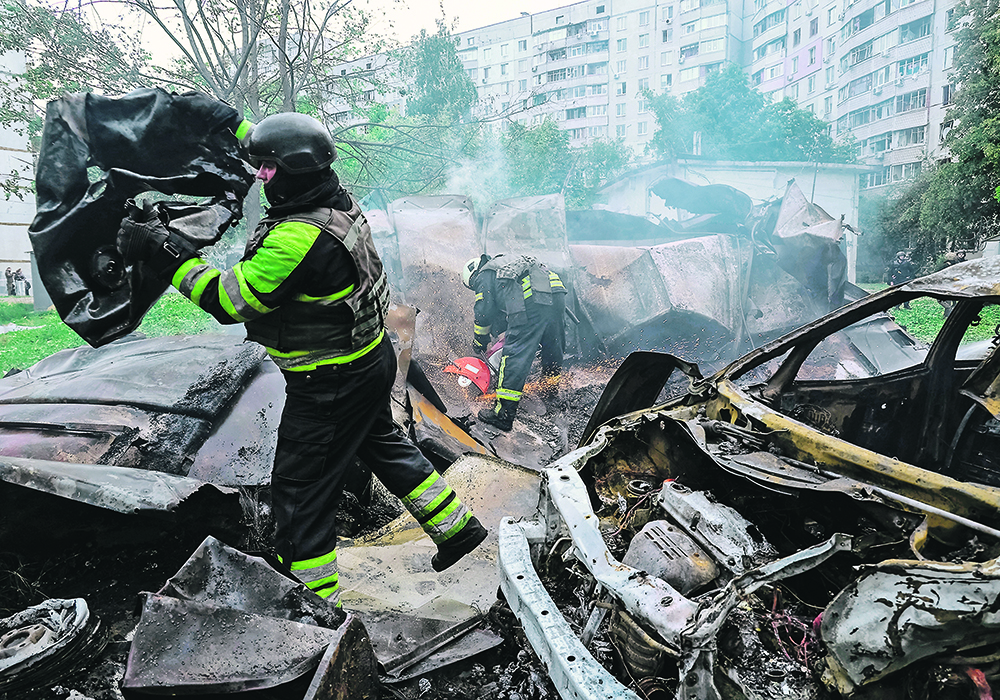 Firefighters work at the site of a Russian air strike in Kharkiv, Ukraine, May 14.  |  Reuters/Sofiia Gatilova photo