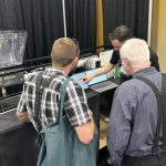 FeedFlo’s Ethan Chochinov demonstrates his company’s product at the World Pork Expo in Des Moines, Iowa. | Ed White photo