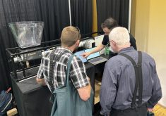 FeedFlo’s Ethan Chochinov demonstrates his company’s product at the World Pork Expo in Des Moines, Iowa. | Ed White photo