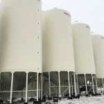 A row of Meridian fertilizer bins sits on screw piles on a farm near Cut Knife, Sask. | Daniel Ouellet photo