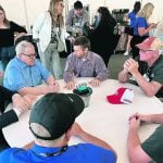 Canadian agriculture minister Lawrence MacAulay, in the light blue shirt, and MP Ted Falk, far left, meet with Iowa hog farmers, as well as Canadian Pork Council chair Rene Roy, right of MacAulay. | Ed White photo