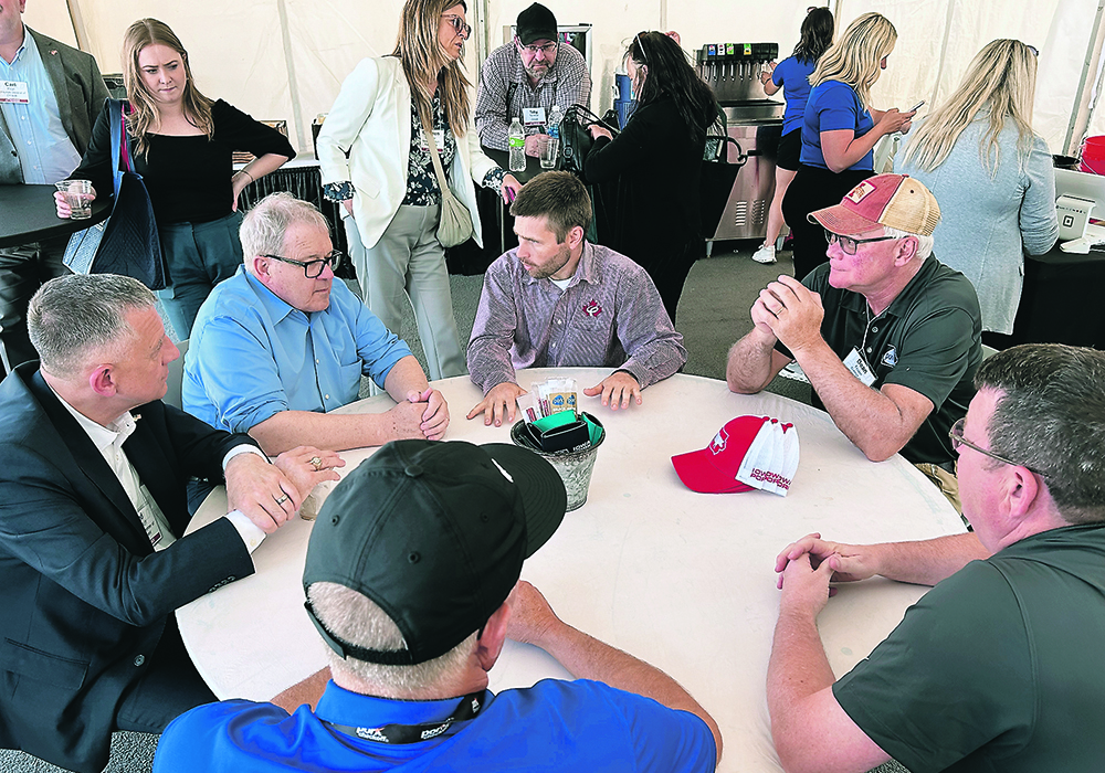 Canadian agriculture minister Lawrence MacAulay, in the light blue shirt, and MP Ted Falk, far left, meet with Iowa hog farmers, as well as Canadian Pork Council chair Rene Roy, right of MacAulay.  |  Ed White photo