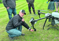 Andrew Kippen points to the nozzle of a spray drone from Green Aero Tech. Kippen’s employer, North Valley Precision Planting, is a dealer for Green Aero Tech.  |  Don Norman photo