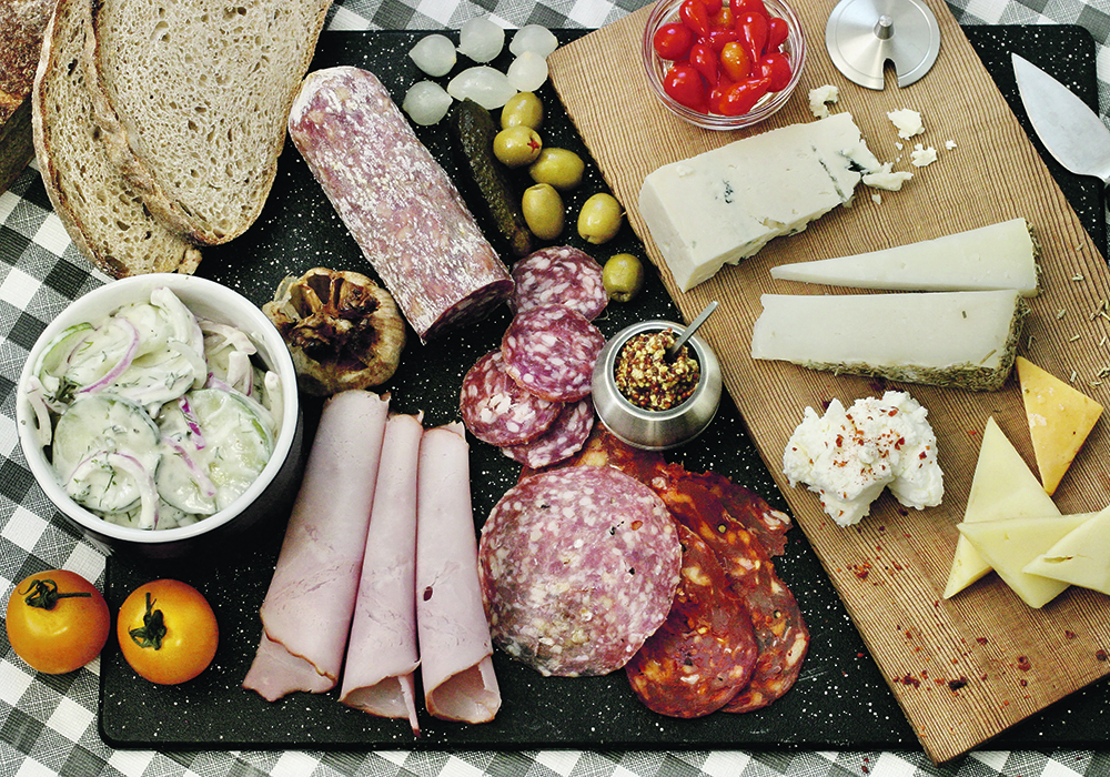 Make a simple picnic platter with cucumber yogurt dill salad, devilled eggs, cold sliced meats, sourdough bread, mustards and tomatoes.  |  Sarah Galvin photo