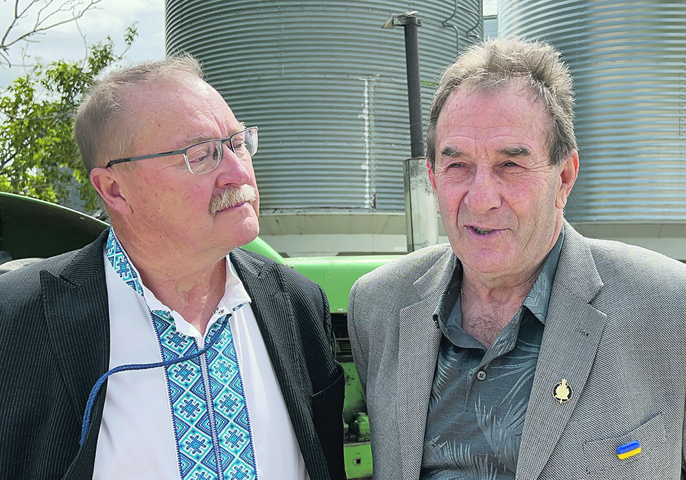 Farmer Ernie Sirski, left, whose farm hosted the recent meeting of Soy Canada and the Manitoba Soybean and Pulse Growers Association, stands with Manitoba agriculture minister Ron Kostyshyn during the event.  |  Ed White photo