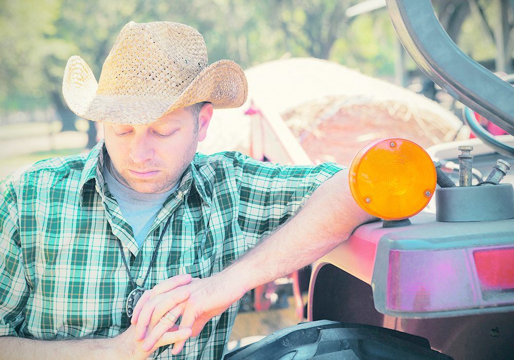 Long hours in the tractor and late nights calving can affect employees in ways that are not always obvious. | Getty Images