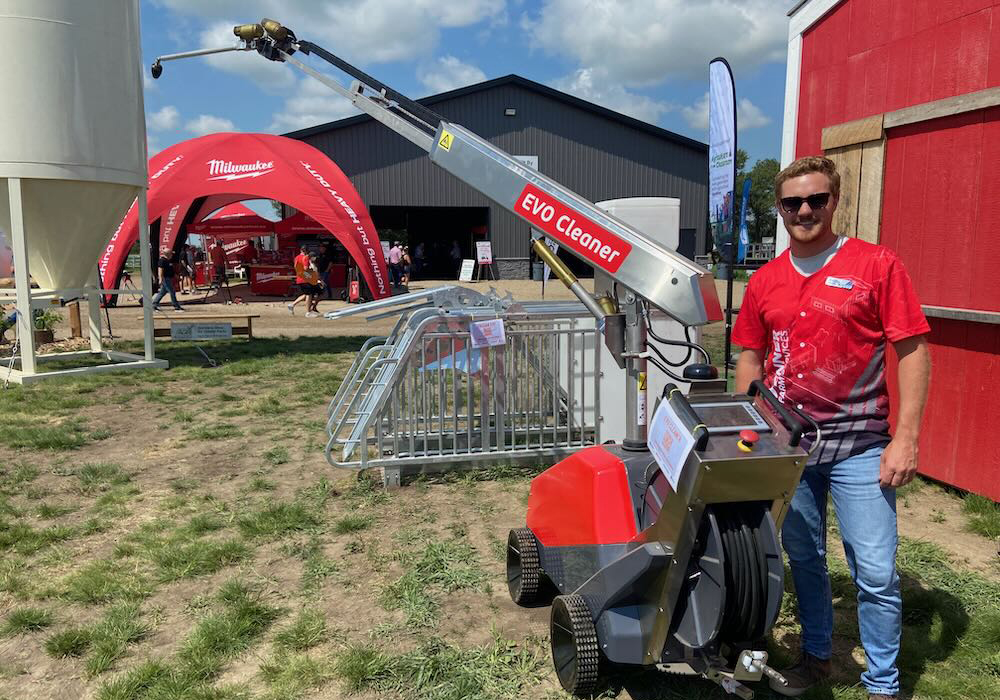 Kolby Woods, of New Standard Ag stands by the Evo Cleaner, a new automated cleaner for livestock barns. | John Greig photo