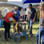Vince Tucker of Hypertherm, one of the record 607 exhibitors at Ag in Motion, demonstrates their plasma cutter to farmers on July 16, 2024. | Michael Robin photo