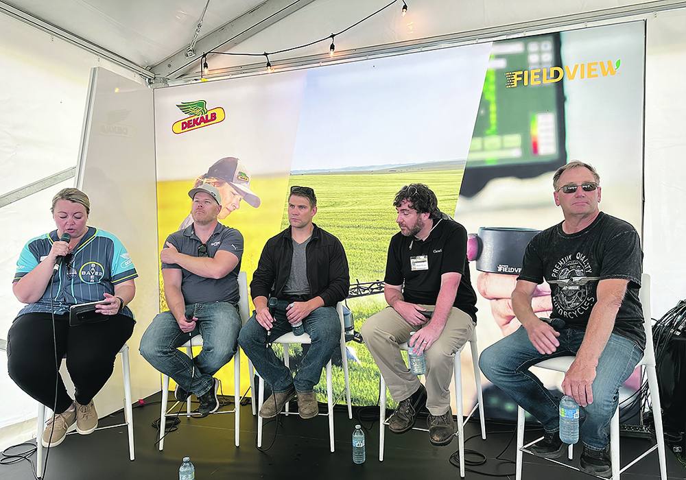 Industry representatives, researchers and farmers discuss the problem of herbicide resistance at the Bayer Crop Science booth at Ag in Motion July 16. Panel moderator Ashley Smith, left, was joined by Rory Cranston and Chris Mansiere of Bayer, Agriculture Canada weed scientist Shaun Sharpe and producer Corey Loessin.  |  Don Norman photo