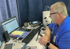 Keith Lundburg of WNAX prepares his next radio broadcoast at the World Pork Expo in Des Moine, Iowa, earlier this summer.  |  Ed White photo