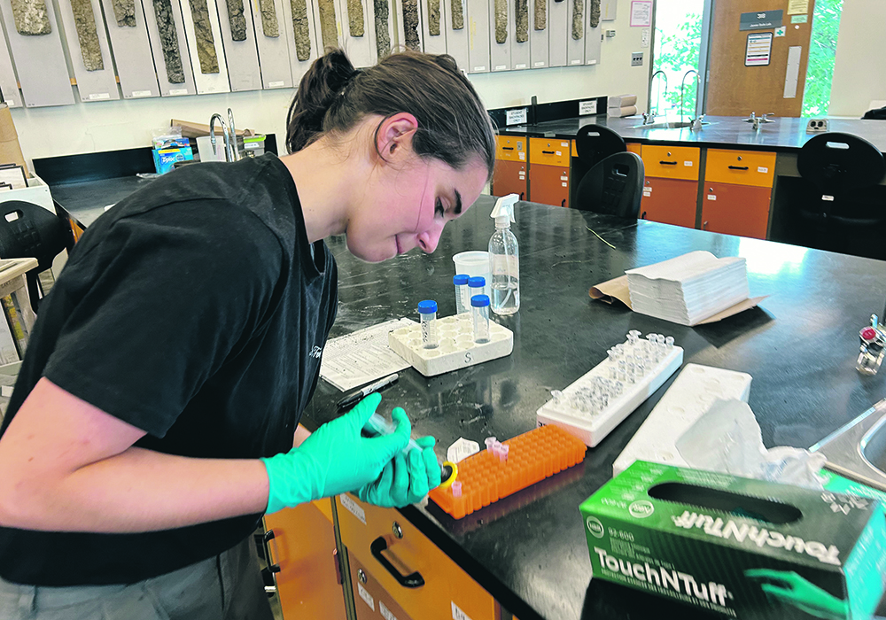 Summer intern Lilly Merz prepares samples. | Ed White photo
