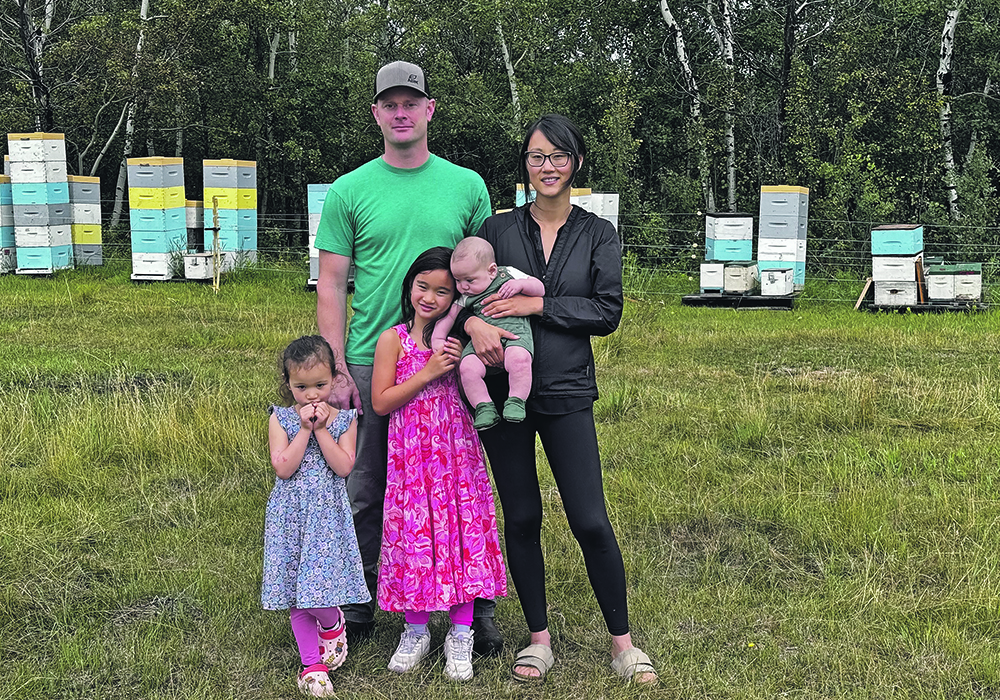 Jason, Songshan, Aaron (in Songshan’s arms) Adelle, front left, and Anna Flint on their farm near Paradise Valley, Alta.  |  Joan Mudryk photo