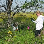 Julia Leeson, right, and a student record vegetation cover data at a field boundary. | Agriculture Canada photo