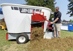 Jerry Oude Egberink, Ontario and Manitoba territory manager, releases a sheep TMR ration from the Jaylor mixer during a demonstration at Canada's Outdoor Farm Show, Sept. 11, 2024. | Stew Slater photo