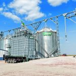 This site in Nebraska features bins, a grain loop handling system and a mixed flow dryer with pre-cleaner. A double run conveyor extends to the top of the dryer in this system. | AGI photo