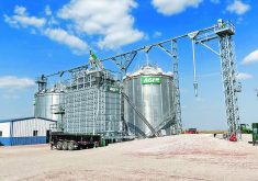 This site in Nebraska features bins, a grain loop handling system and a mixed flow dryer with pre-cleaner. A double run conveyor extends to the top of the dryer in this system.  |  AGI photo
