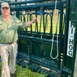 Myron Wigness stands with Hi-Hog squeeze unit at Canada’s Outdoor Farm Show. Photo: John Greig