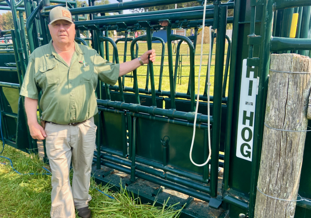 Myron Wigness stands with Hi-Hog squeeze unit at Canada’s Outdoor Farm Show. Photo: John Greig