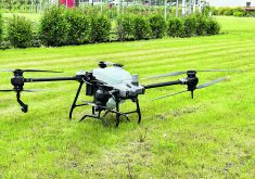 A spray drone used water to demonstrate the potential of the technology during a Manitoba crop tour this summer.  |  Don Norman photo
