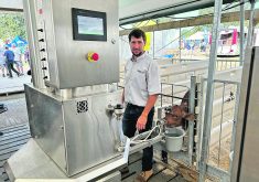 Lester Martin stands with his Uddermatic automated calf feeding system at the Dairy Innovation Centre during Canada’s Outdoor Farm Show.  |  Stew Slater photo