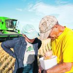 Rob Jones checks wheat with his daughter, Megan, in September before moving onto a new field on his farm near Speers, Sask.
Saskatchewan Agriculture says yields were above the 10-year average for most crops in the province. | NATHAN JONES PHOTO