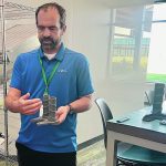 Judd Maxwell, Syngenta’s head of North American Corn Product Placement, shows a model of the stock crusher used by the company to automatically measure standability of corn. | John Greig photo