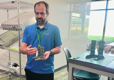 Judd Maxwell, Syngenta’s head of North American Corn Product Placement, shows a model of the stock crusher used by the company to automatically measure standability of corn.  |  John Greig photo