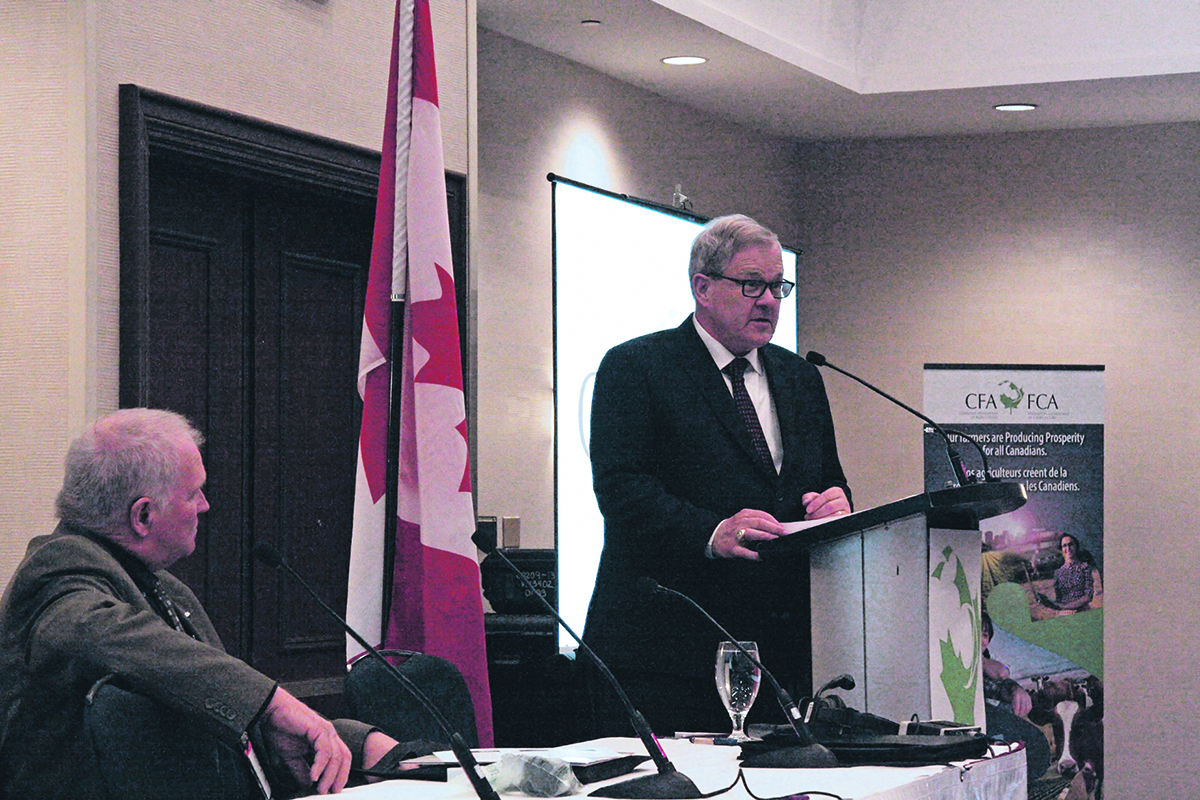 In one of his last addresses to farmers before being shuffled, federal agriculture minister Lawrence MacAulay opens the Canadian Federation of Agriculture annual meeting in Ottawa. Looking on is now past-president Ron Bonnett. | Karen Briere photo
