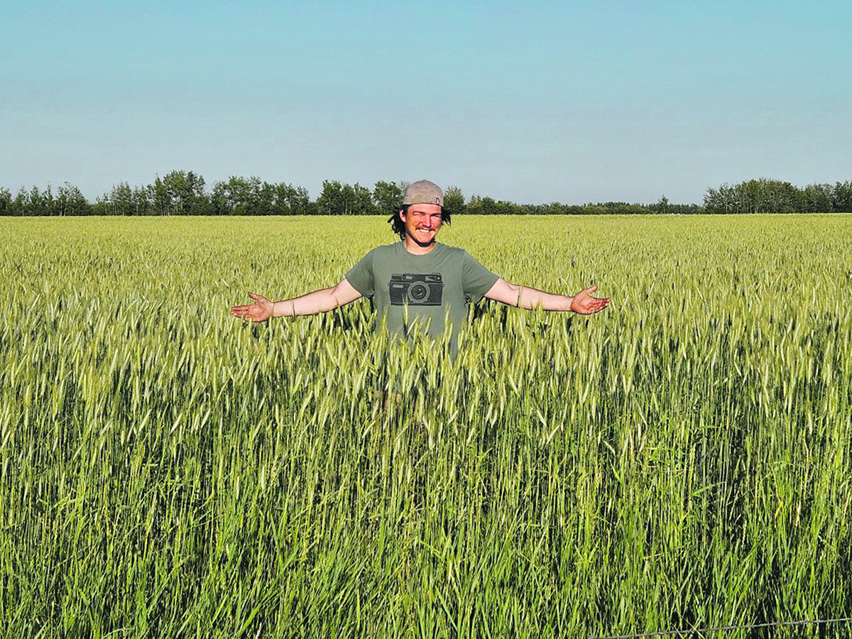 Lukijan Strebchuk stands in a healthy winter triticale crop on his family’s farm, which is making cover cropping work in northwestern Alberta. | Supplied photo