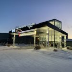 Exterior view of the World Trade Center in Saskatoon, showcasing the entrance with illuminated signage.