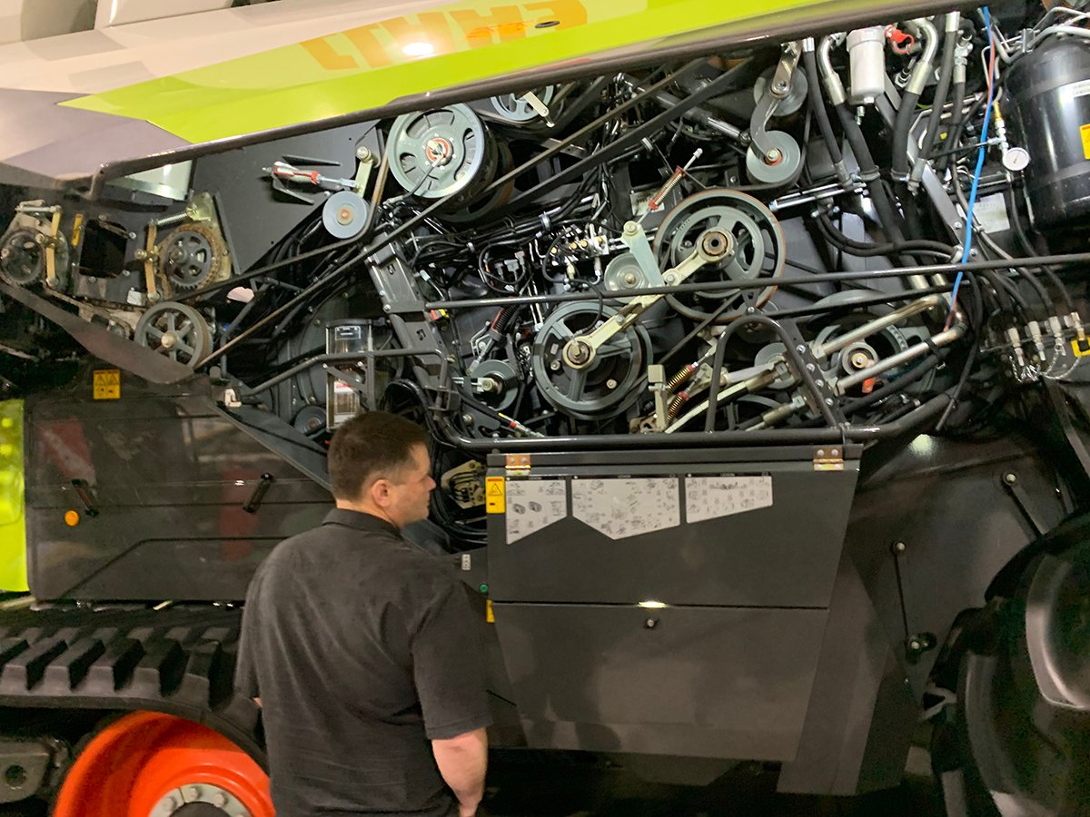 A farmer looks at a new Claas combine at the 2025 Crop Production Show in Saskatoon.