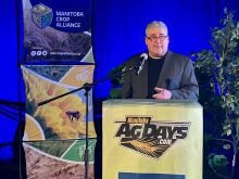 Mike Jubinville, a senior markets analyst with Glacier MarketsFarm, speaks at a Manitoba Ag Days podium.