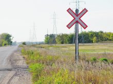 Photo of the railway crossing sign at an uncontrolled rail crossing in the country.