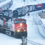 A CN train is seen in a snowy rail yard.