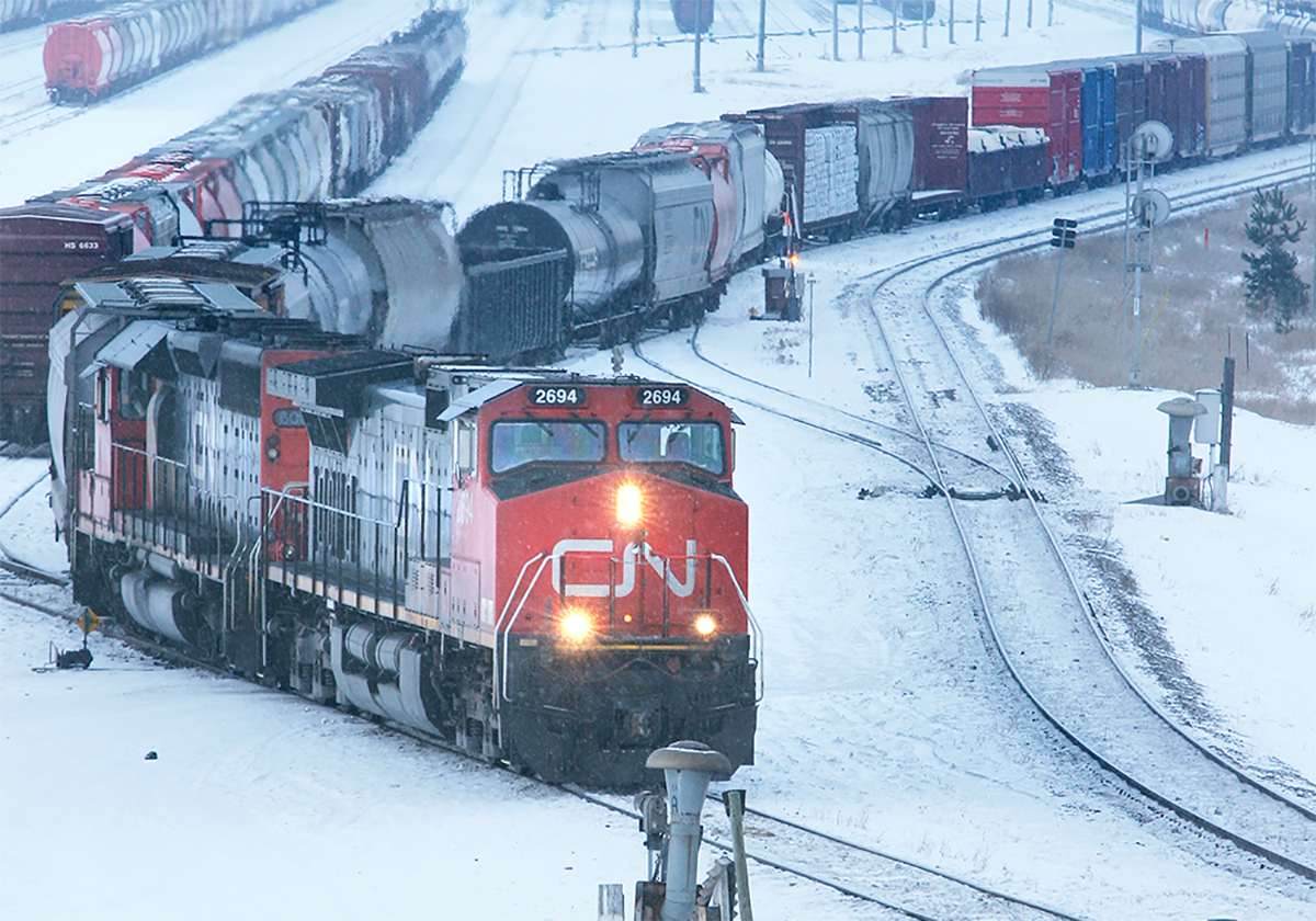 A CN train is seen in a snowy rail yard.