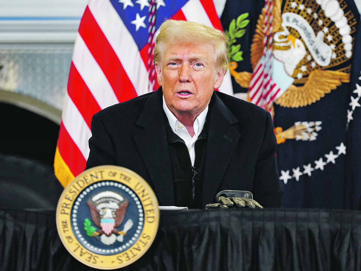 U.S. president Donald Trump speaks from a lectern with the presidential seal on it.