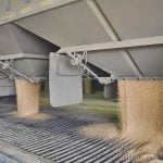 Grain is dumped from the bottom of a trailer at an inland terminal.