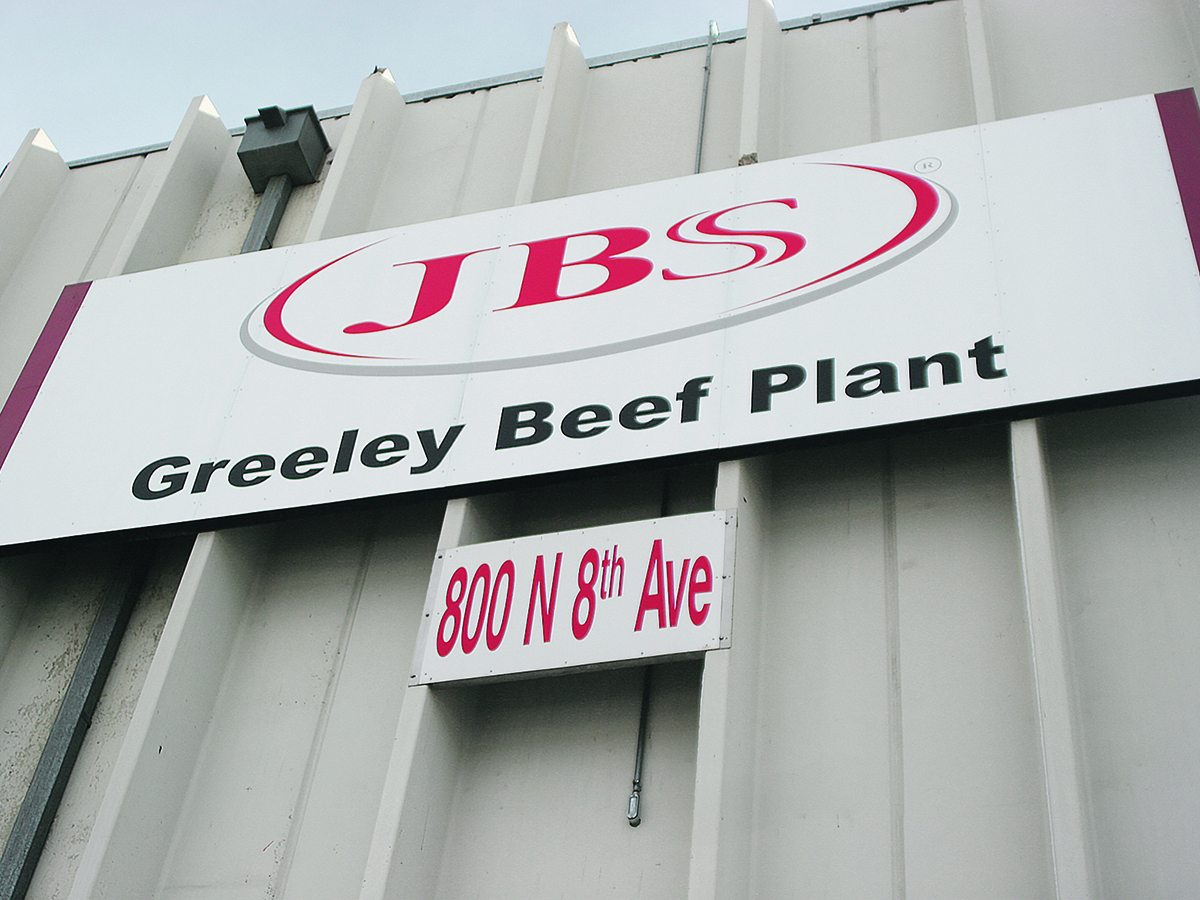 Looking up at the JBS sign on the side of their Greely, CO, beef plant.