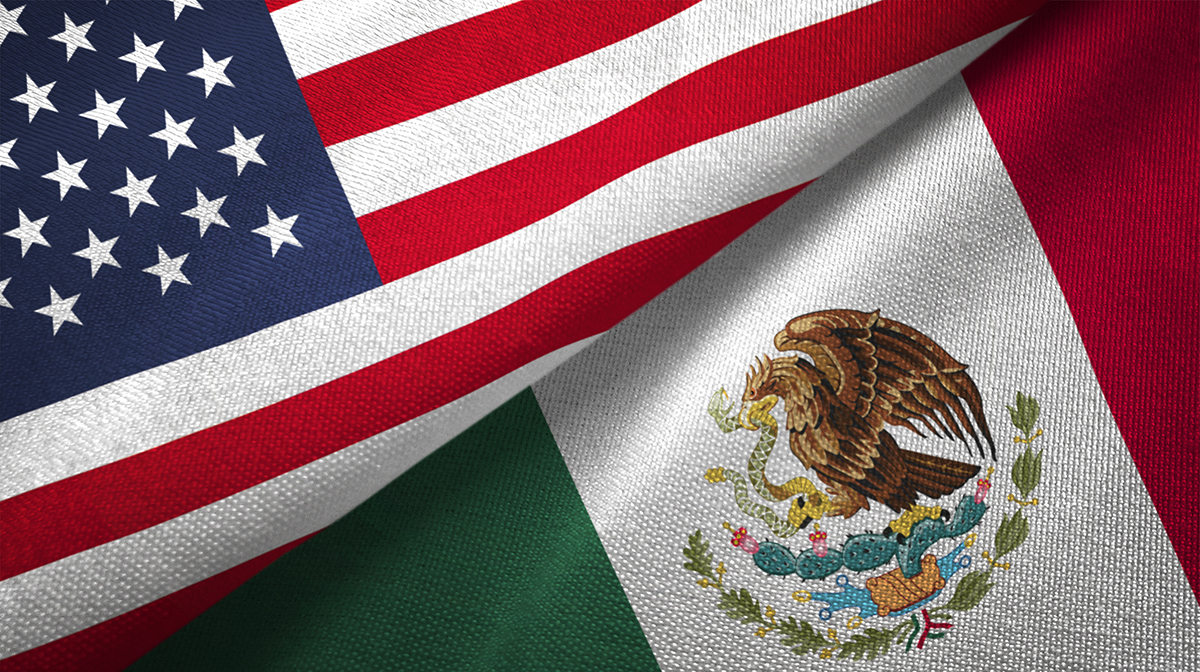 A U.S. flag on top of a Mexican flag.