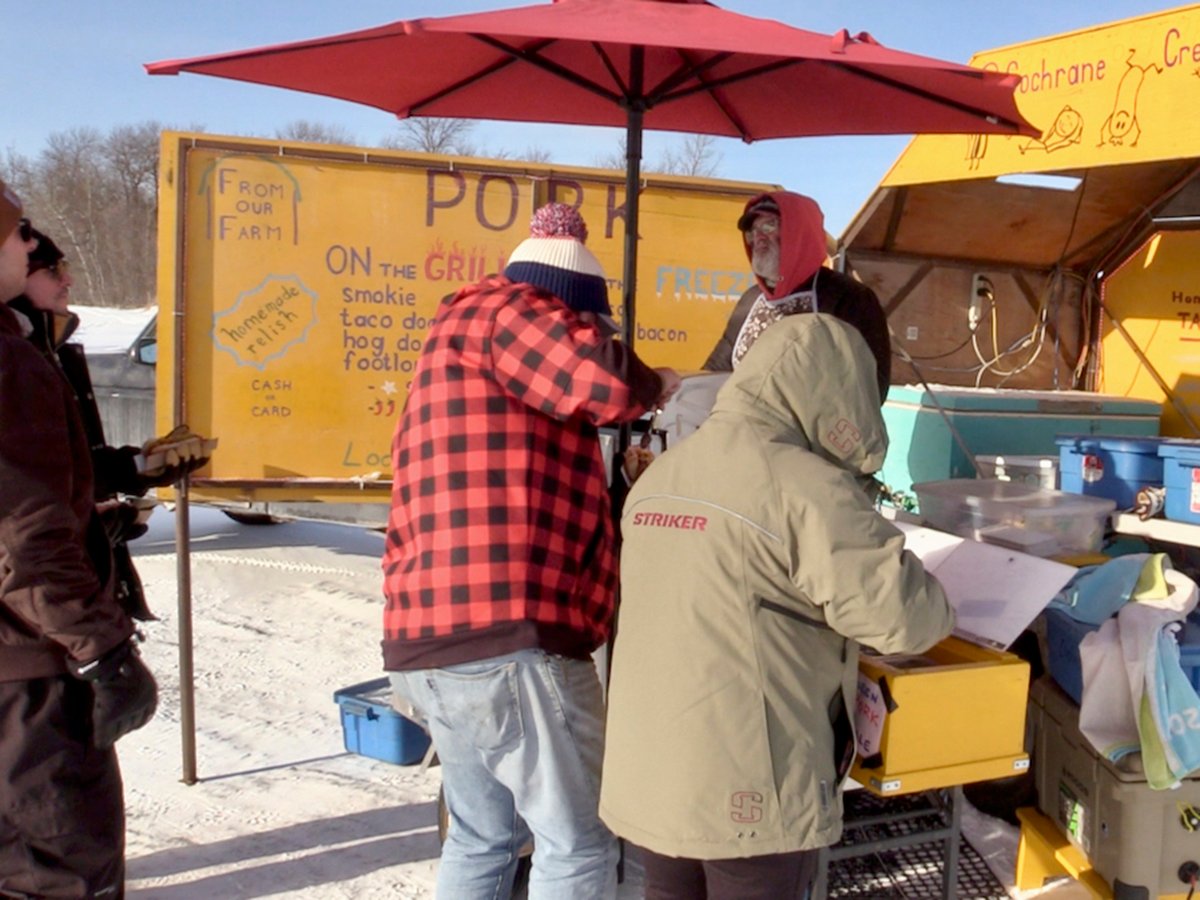 Rudy Wall of Cochrane Creek Farm selling hot dogs from his cart on the Lake Winnipeg ice on Jan. 19, 2025.