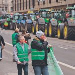 A long line of tractors is parked end-to-end on a city street as German farmers protest against plans to end subsidies or tax breaks on agricultural diesel, among other things, in 2024.