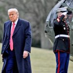 U.S. president Donald Trump leaves the Marine 1 helicopter on the south lawn of the White House.