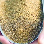 Canola meal in a small container.