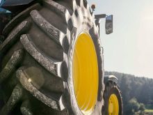 A photo of a large tractor tire on a tractor.
